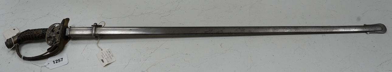 An 1889 Wilhelm II Prussian infantry officer’s sword with folding side guard, in a steel scabbard, blade 83.5cm. Condition - fair, worn overall